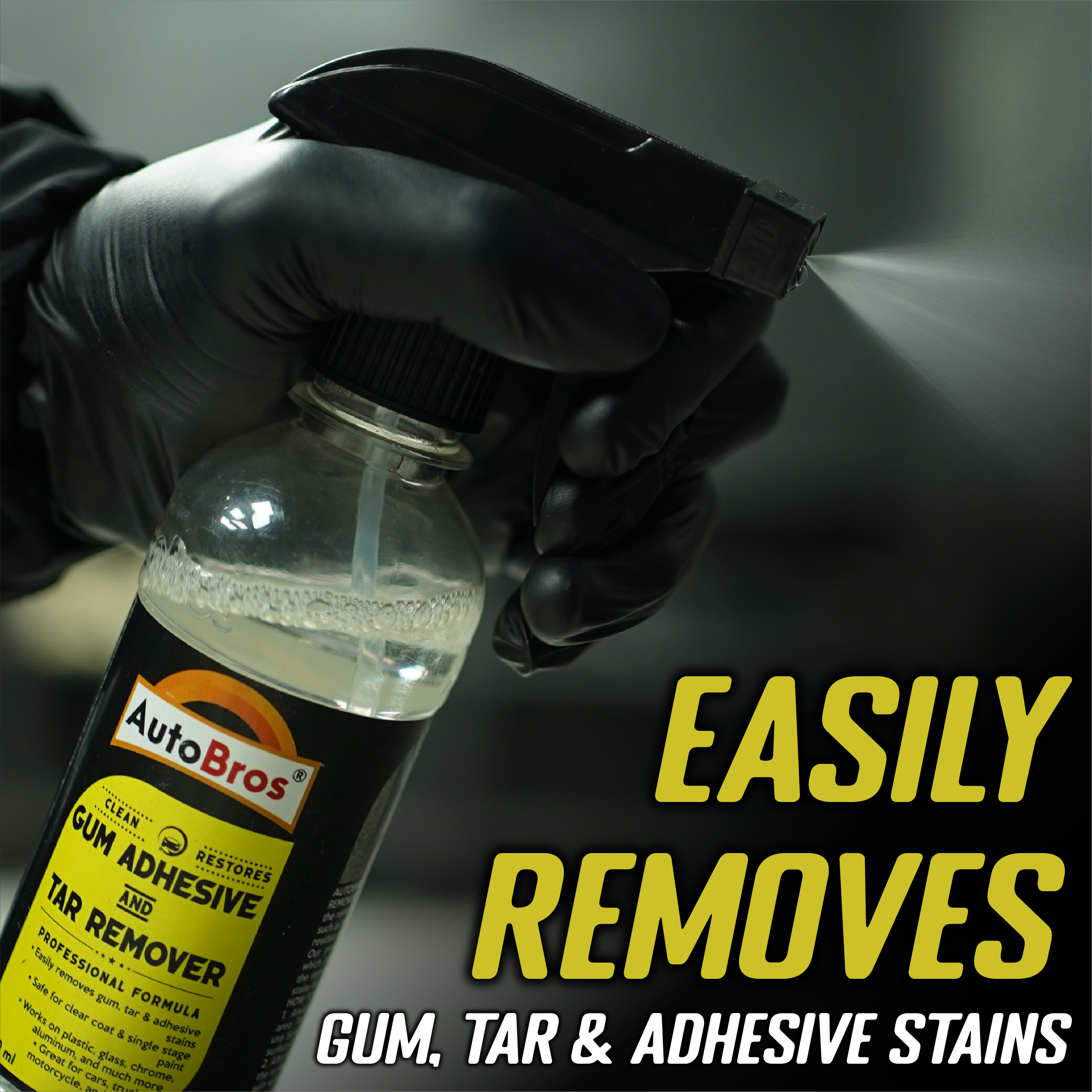 Hand holding a bottle of AutoBros gum, tar, and adhesive remover with text on a dark background