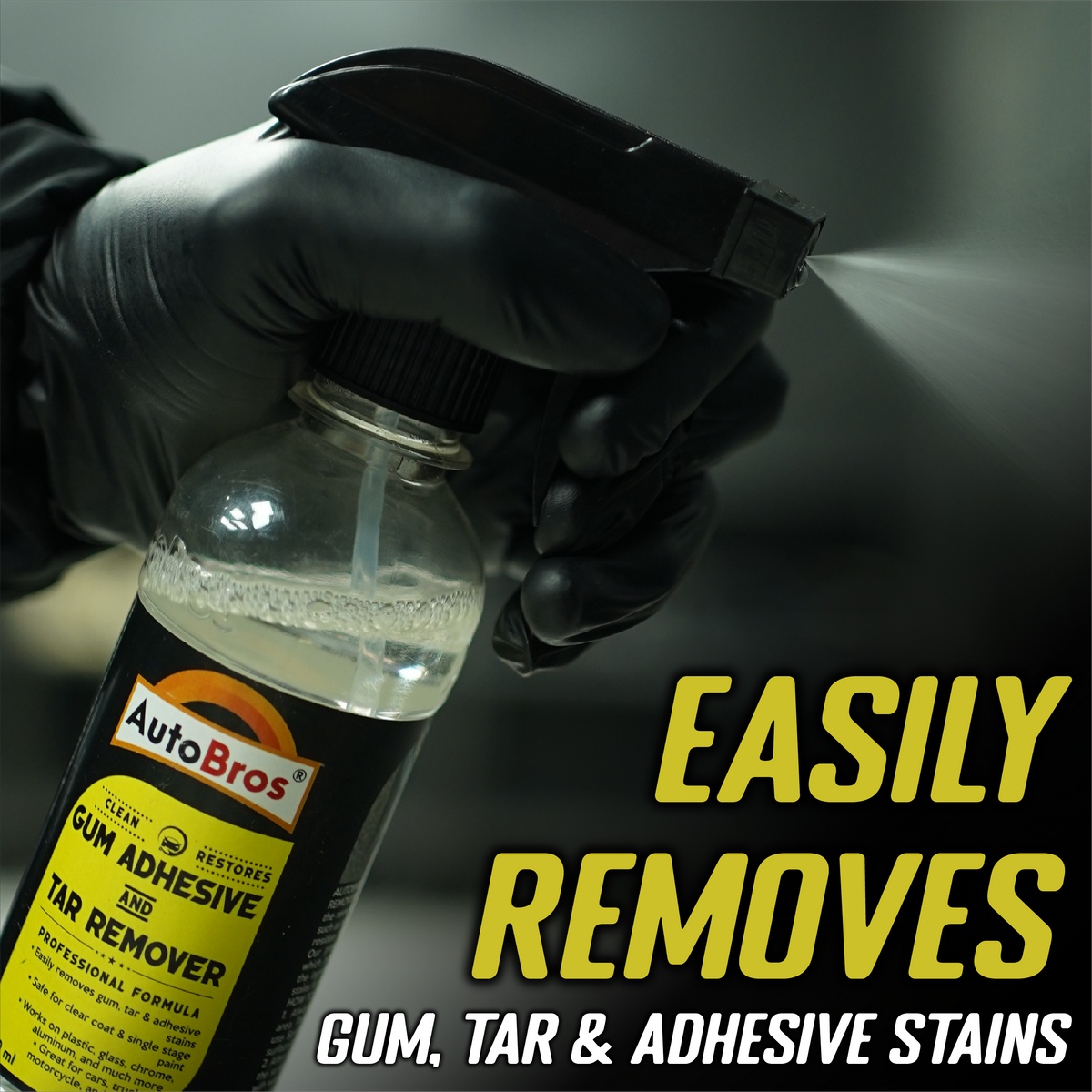 Hand holding a bottle of AutoBros gum, tar, and adhesive remover with text on a dark background