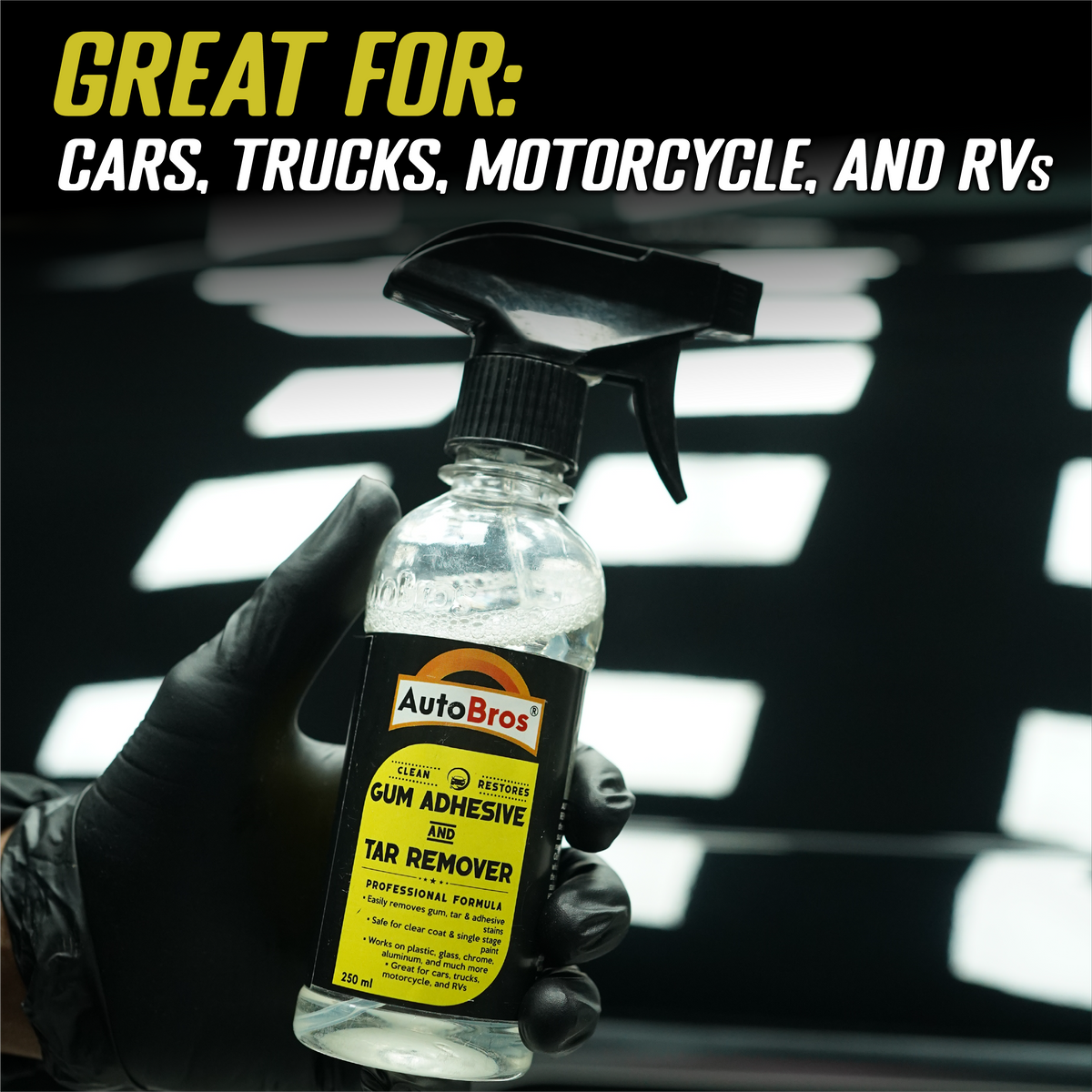 Bottle of AutoBros gum adhesive and tar remover held by a gloved hand with text indicating its use on cars, trucks, motorcycles, and RVs.