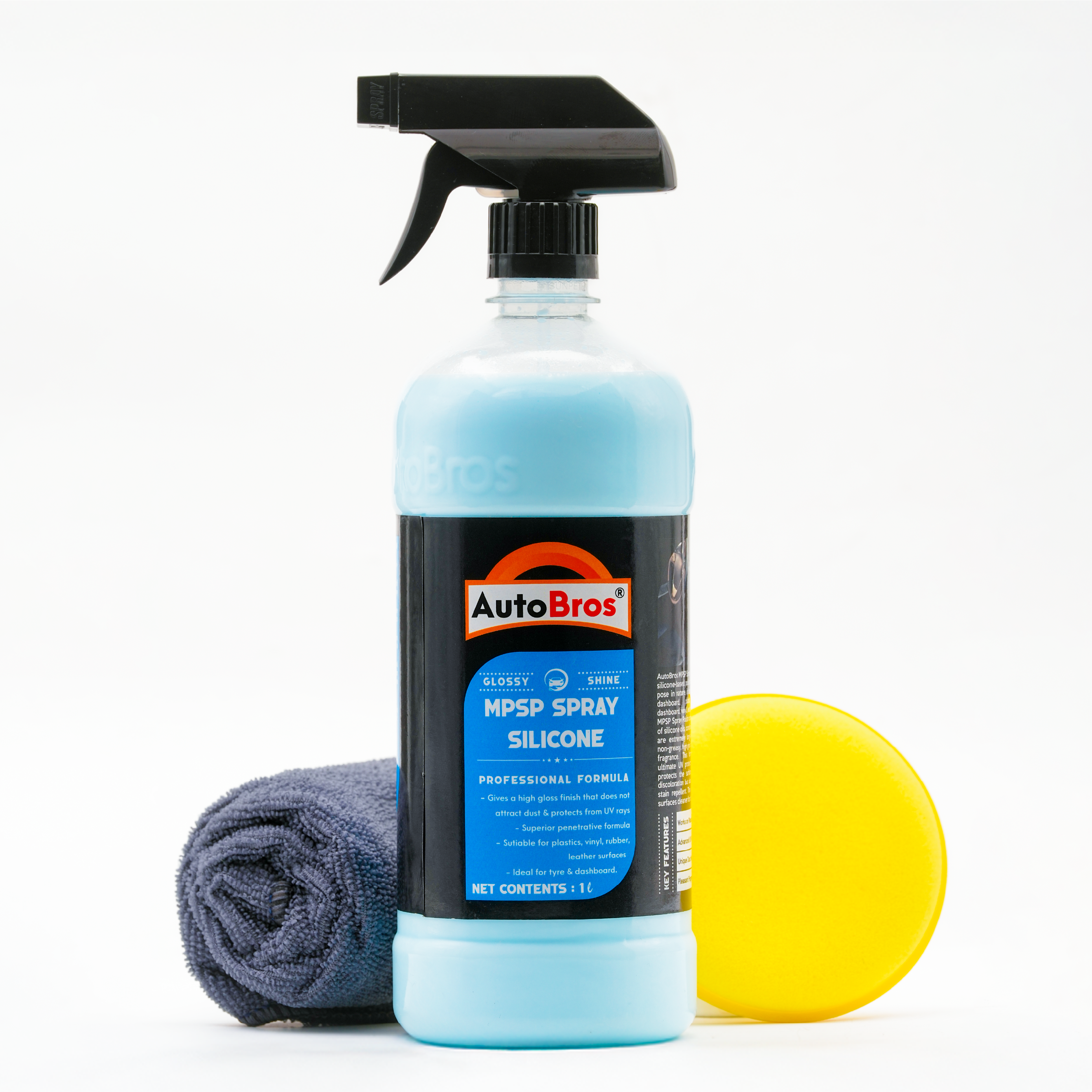Car care product set with spray bottle, microfiber cloth, and yellow polishing pad on a white background