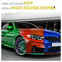 Multicolored car with a high-gloss finish in front of a building.